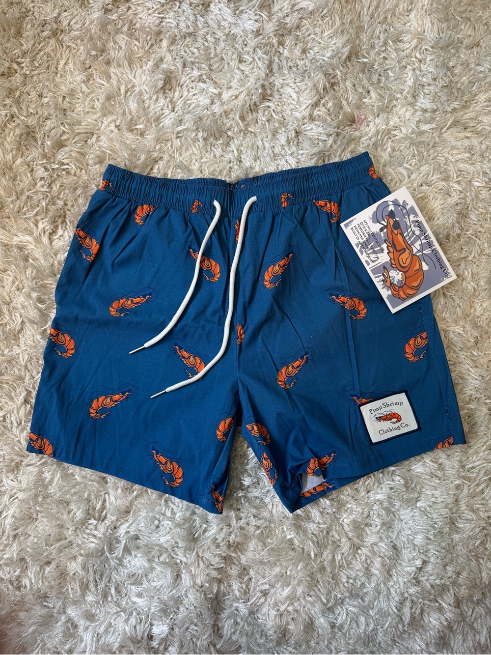 Pimp Shrimp Clothing Co. Men’s Blue Swim Trunks with Orange Shrimp Print
